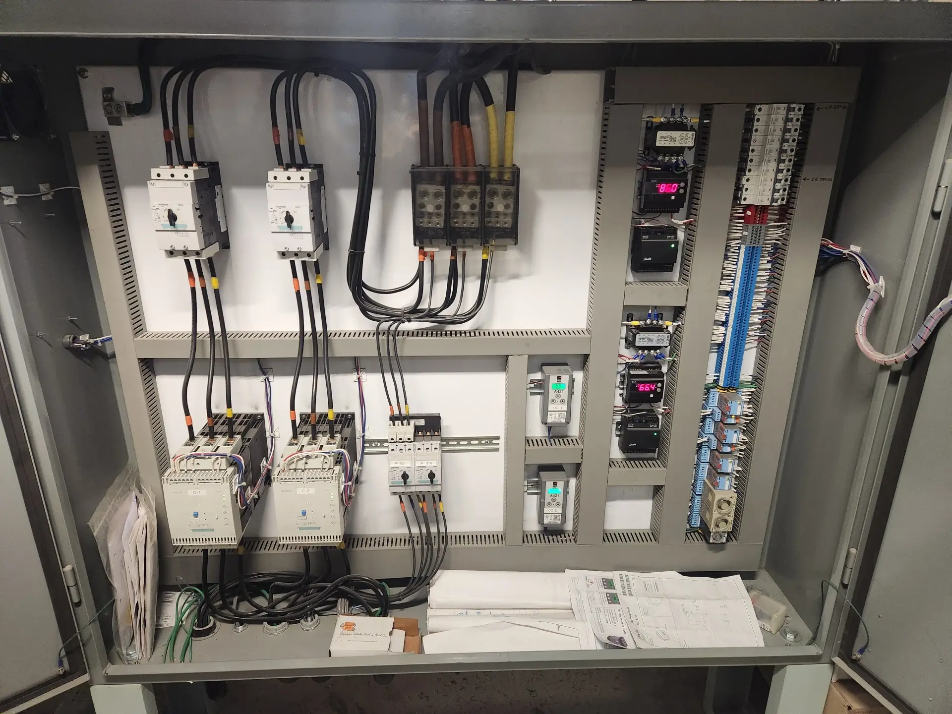 A view of an electrical panel with many wires.